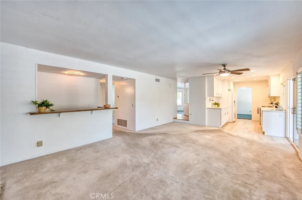 The remodeled kitchen opens to the spacious family room, complete with a wet bar, offering comfortable everyday living and easy hosting.