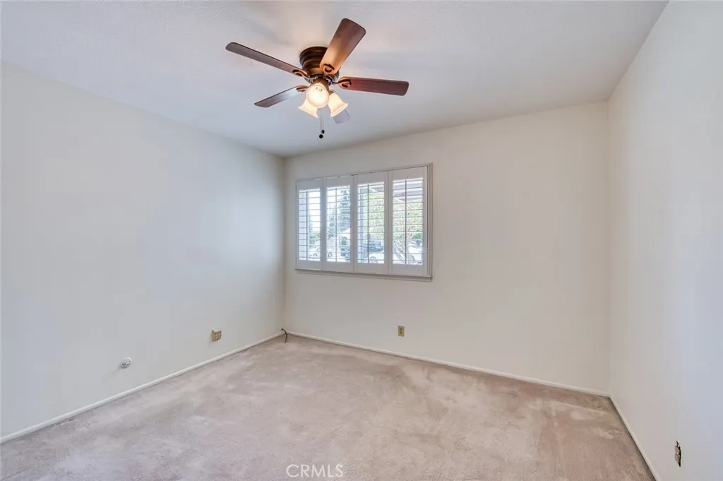 Main floor bedroom with ceiling fan.