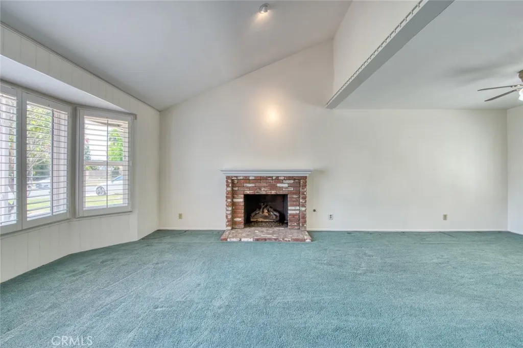 Southern facing living room with cozy fireplace, vaulted ceiling and flows seamlessly into the dining room.