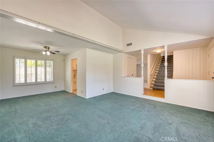 Living room with vaulted ceiling flows seamlessly into the dining room.