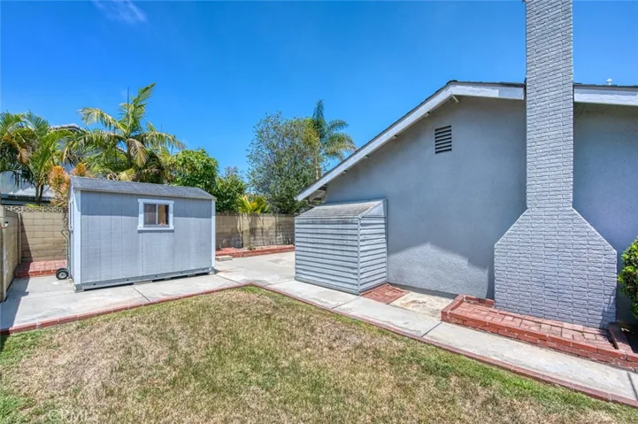 Side yard with grass area and shed.