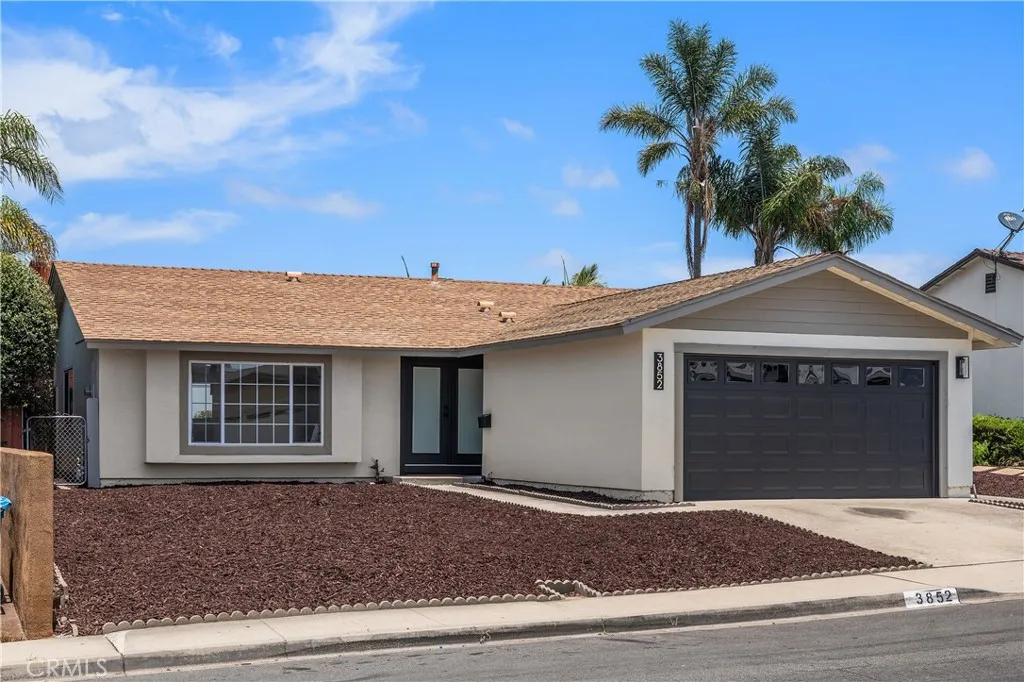 Property has been freshly painted in a modern color palette and enhanced with striking black accents, including a contemporary front door, updated address numbers, lighting, and a sleek mailbox. A charming box bay window adds architectural interest and character, completing the clean, stylish curb appeal.