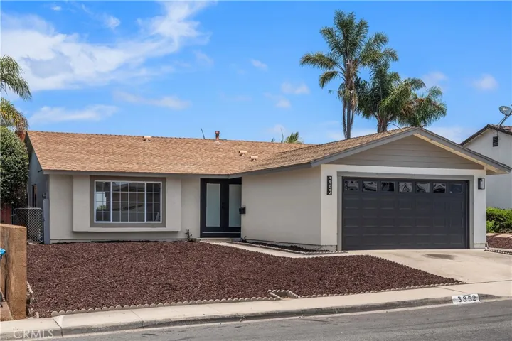 Property has been freshly painted in a modern color palette and enhanced with striking black accents, including a contemporary front door, updated address numbers, lighting, and a sleek mailbox. A charming box bay window adds architectural interest and character, completing the clean, stylish curb appeal.