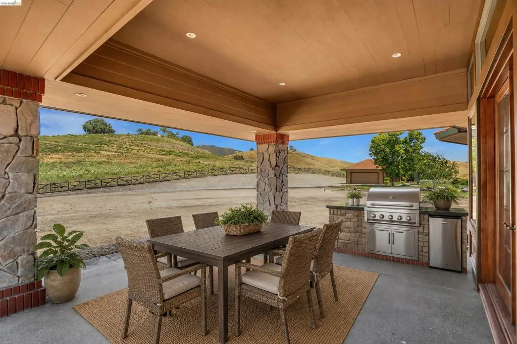 Covered patio with stone pillars and wood-finish ceiling