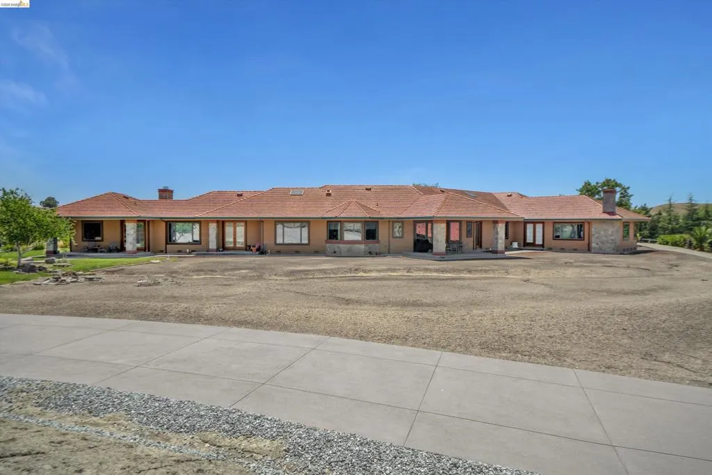Single-story stucco residence with a terracotta tile roof