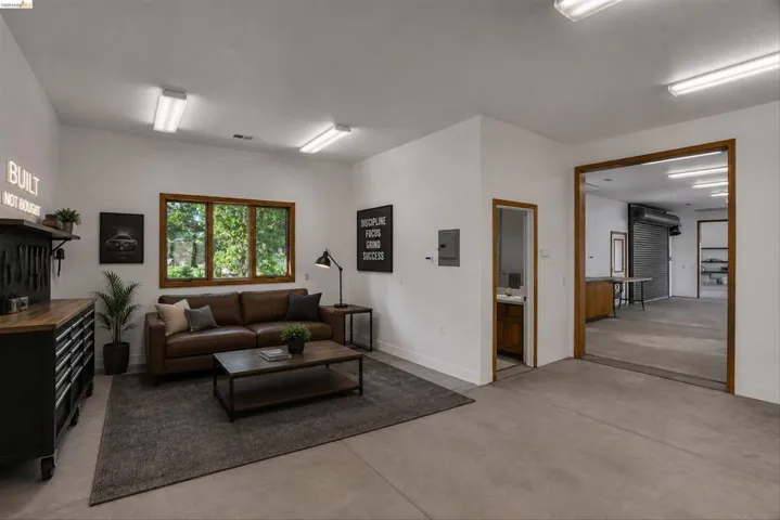 Versatile interior space featuring concrete flooring and white walls