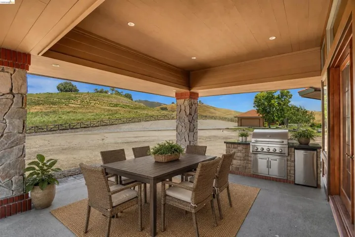 Covered patio with stone pillars and wood-finish ceiling