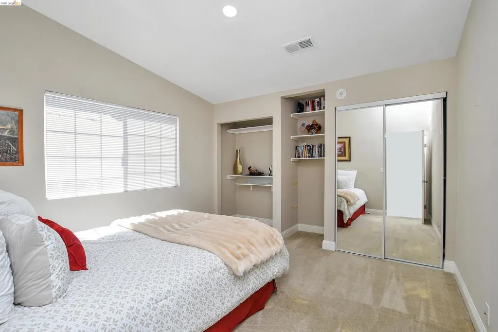 Neutral tone walls with vaulted ceiling and recessed lighting