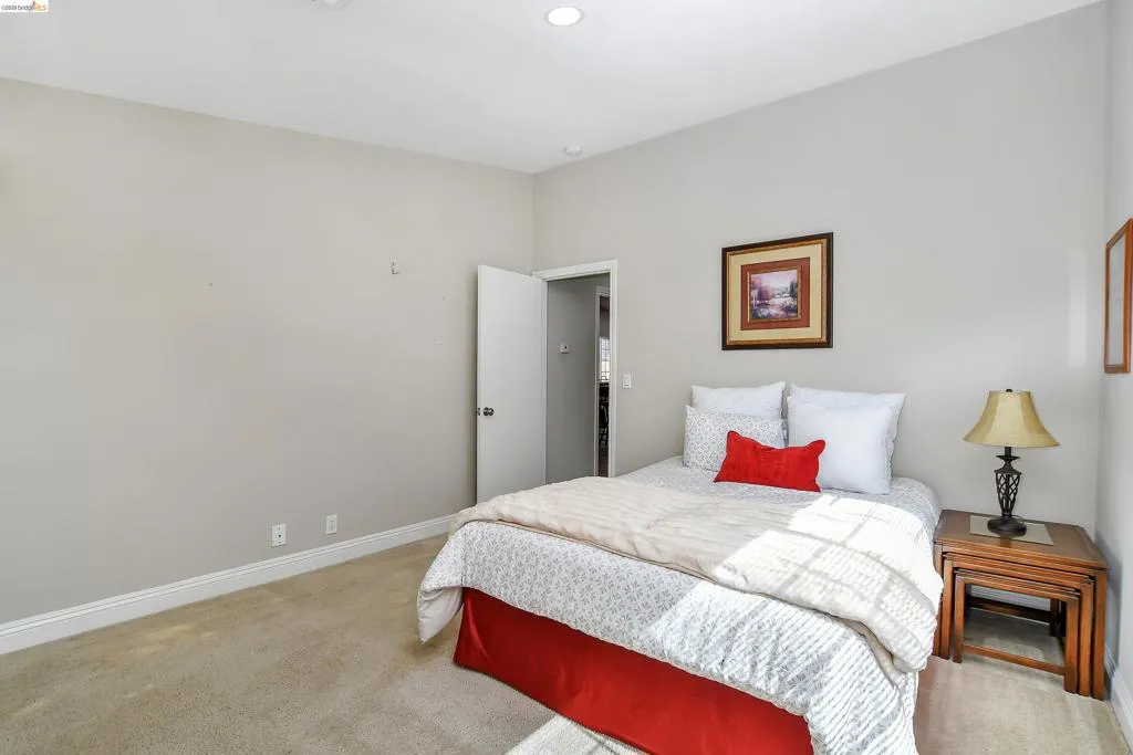 Carpeted room featuring recessed lighting, light-toned wall paint, white baseboards, and a solid core door