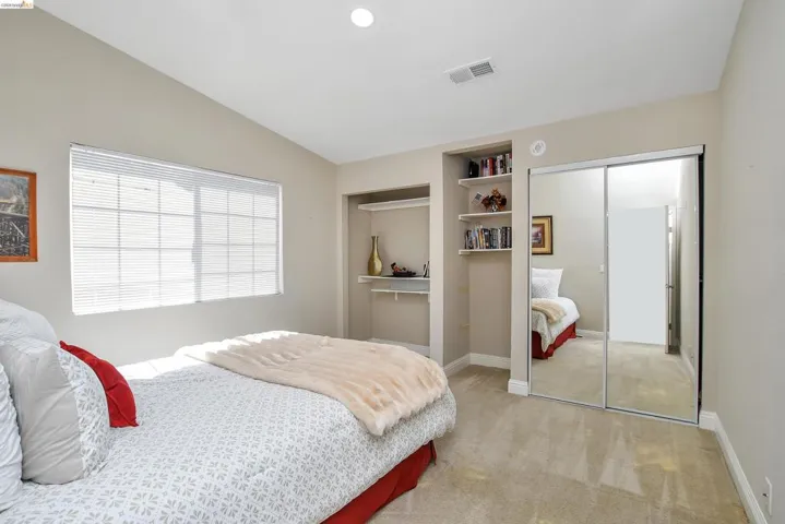 Neutral tone walls with vaulted ceiling and recessed lighting