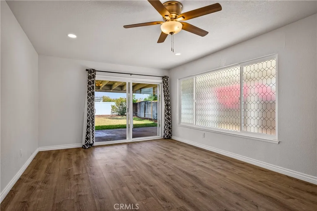 Family room with newer recessed lighting and fan.