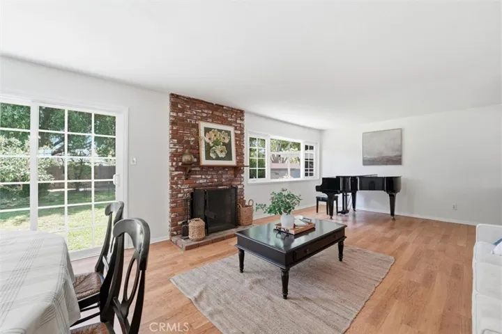 Living room with lots of windows overlooking backyard