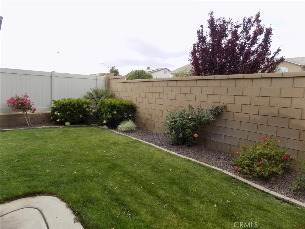 Mature landscaping including many rose bushes and trees