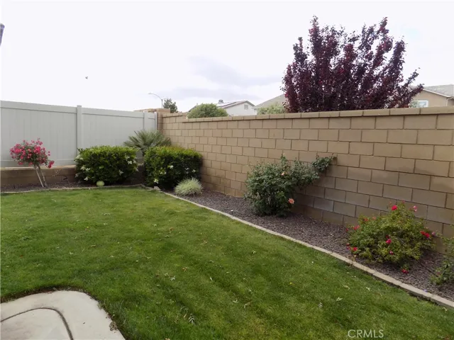 Mature landscaping including many rose bushes and trees