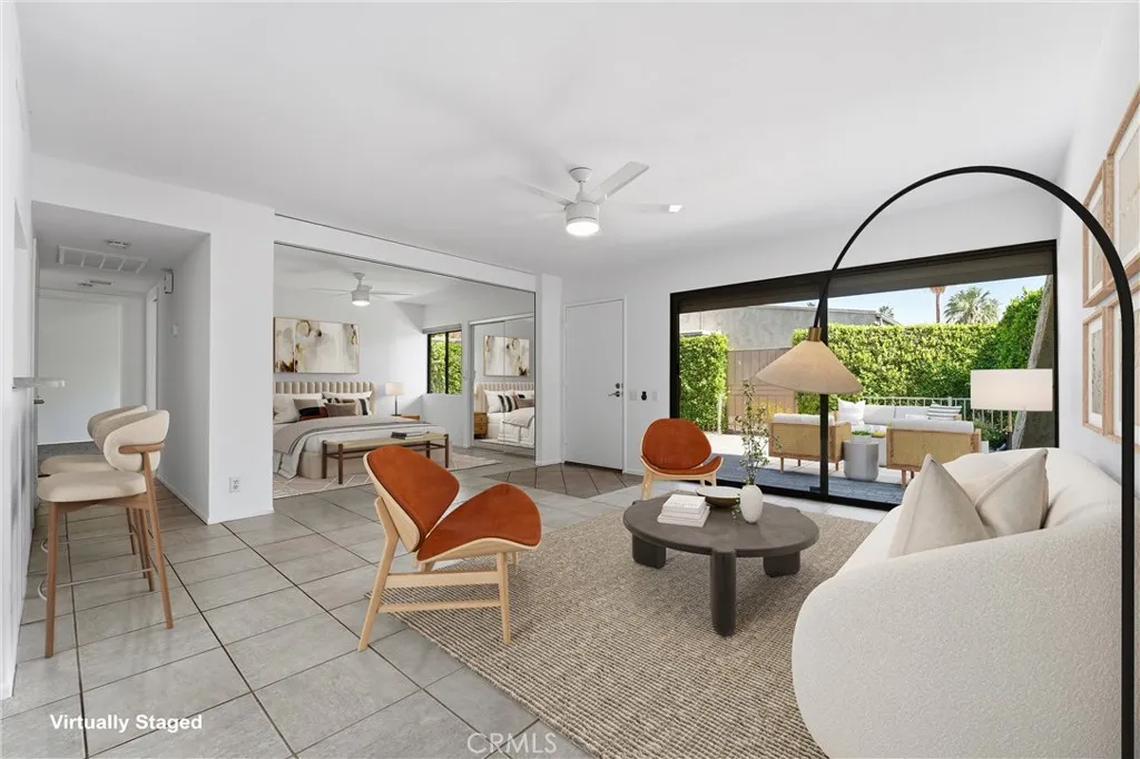 Virtually staged living area with custom motorized wall to 2nd bedroom open