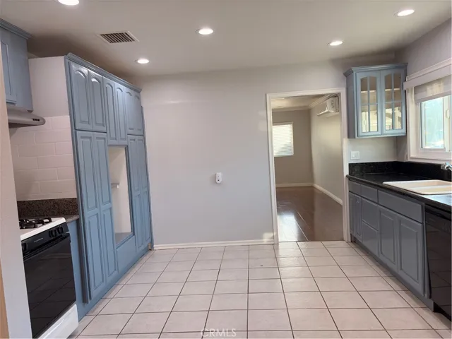 Bright kitchen area with many cabinets