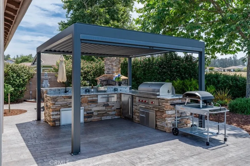 Another View of Covered Outdoor Kitchen With a Motorized Pull-Down 
Privacy Screen