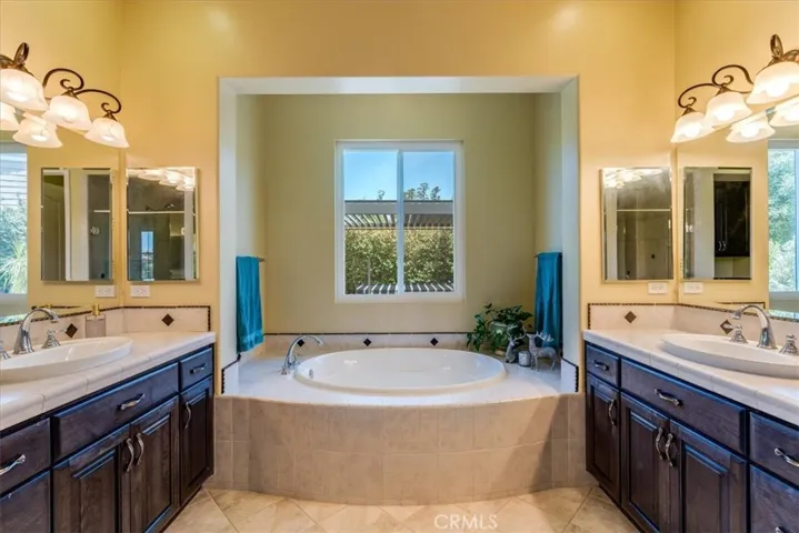 Primary Ensuite Bathroom With Tub, Dual Sinks, & Separate Walk-In Shower