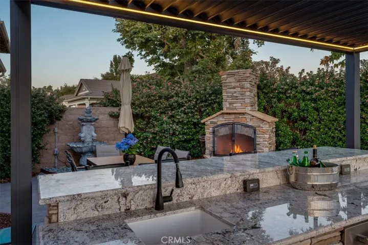 Outdoor Kitchen With Granite Countertop and Hot Water Sink