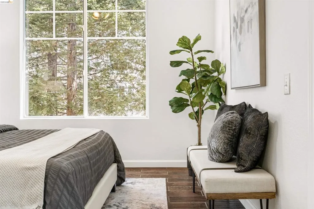 Bedroom with dark wood finished floors and baseboards