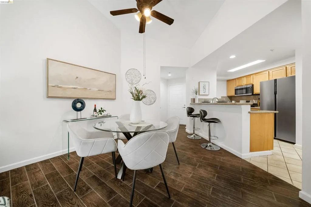 Dining space featuring wood tiled floors, ceiling fan, and recessed lighting