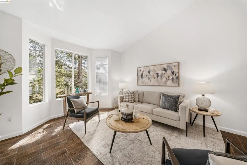 Living area featuring wood finish floors and vaulted ceiling