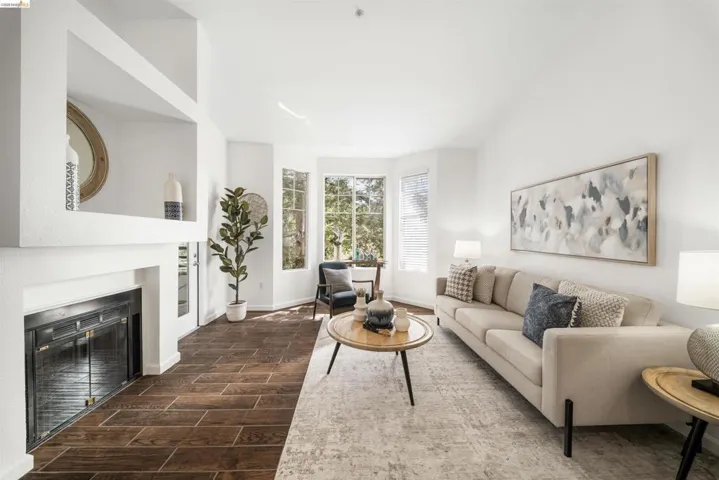 Living area featuring wood tiled floors and a glass covered fireplace