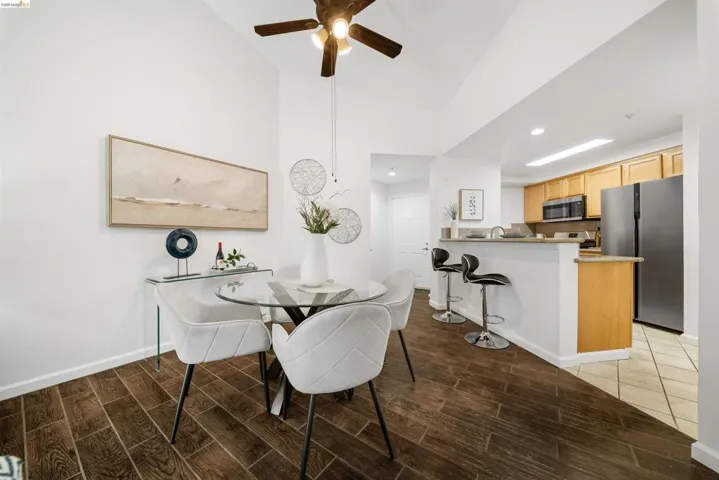 Dining space featuring wood tiled floors, ceiling fan, and recessed lighting