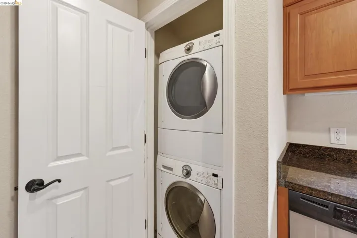 Convenient stackable washer and dryer within a dedicated utility closet
