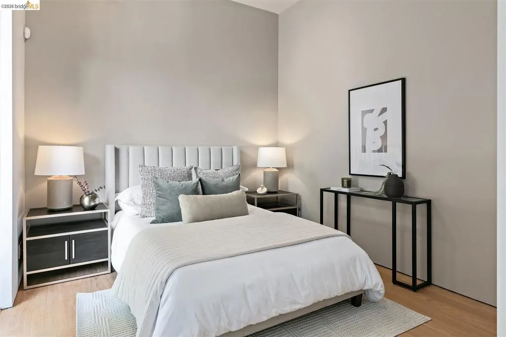 Light-toned walls complement the wood-finish flooring in this bedroom
