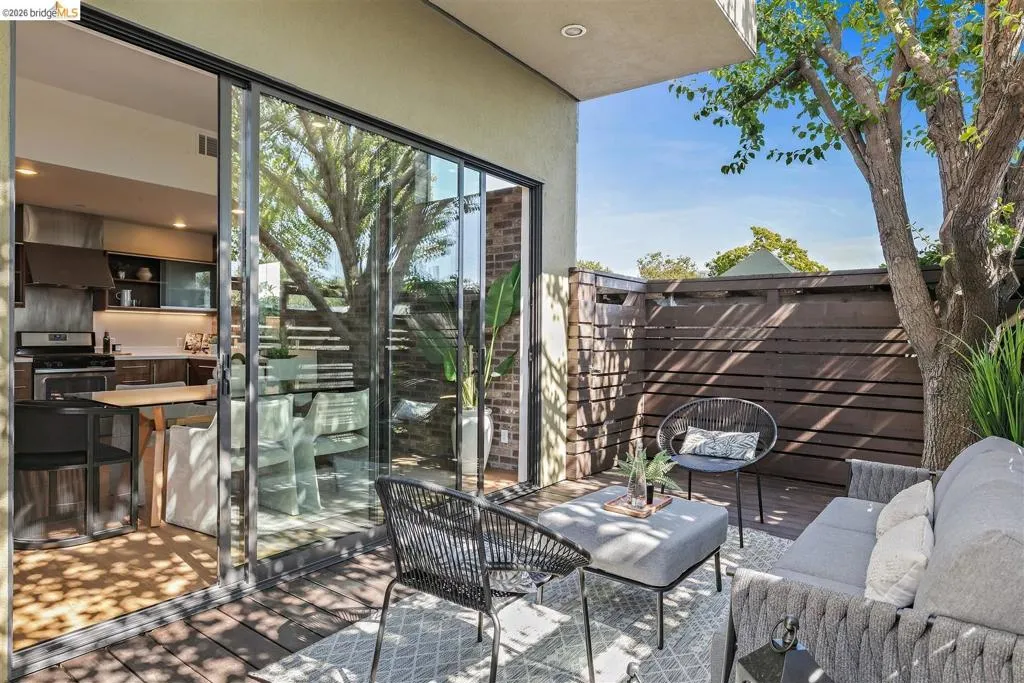 Outdoor patio with wood-finish decking and privacy fencing