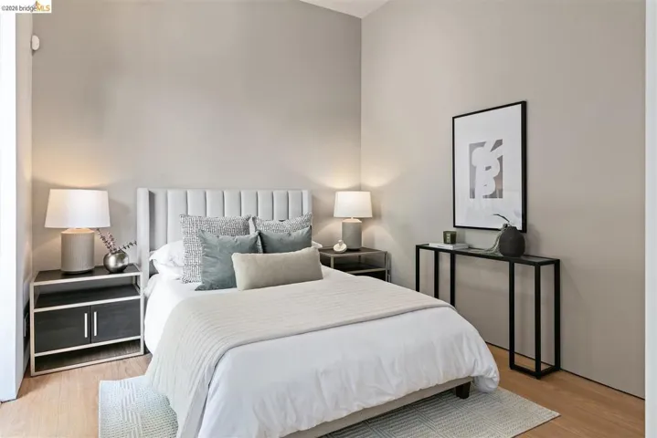 Light-toned walls complement the wood-finish flooring in this bedroom