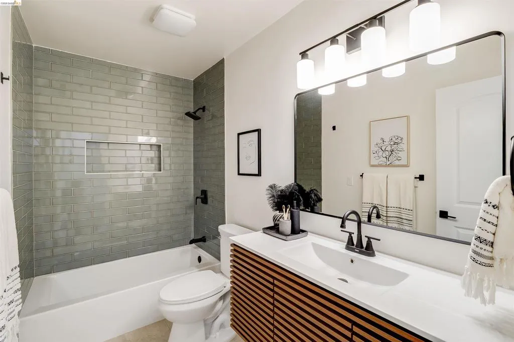 Bathroom featuring a tub/shower combination with subway tile surround and integrated niche