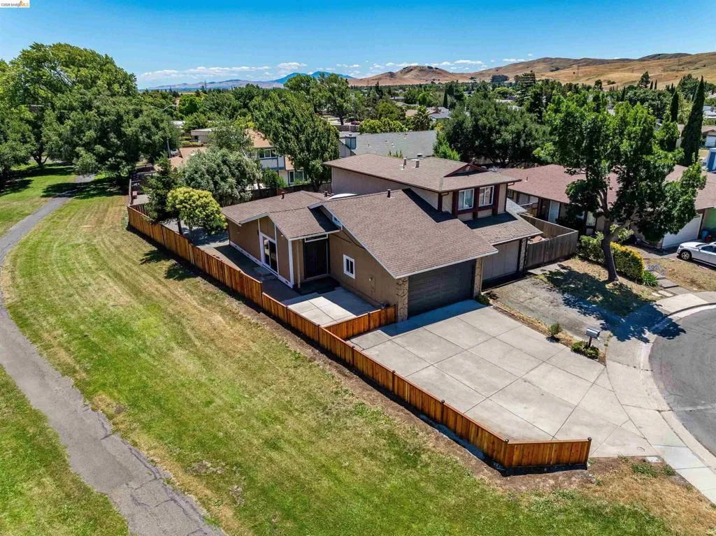 Single-story residence featuring a brown exterior with white trim