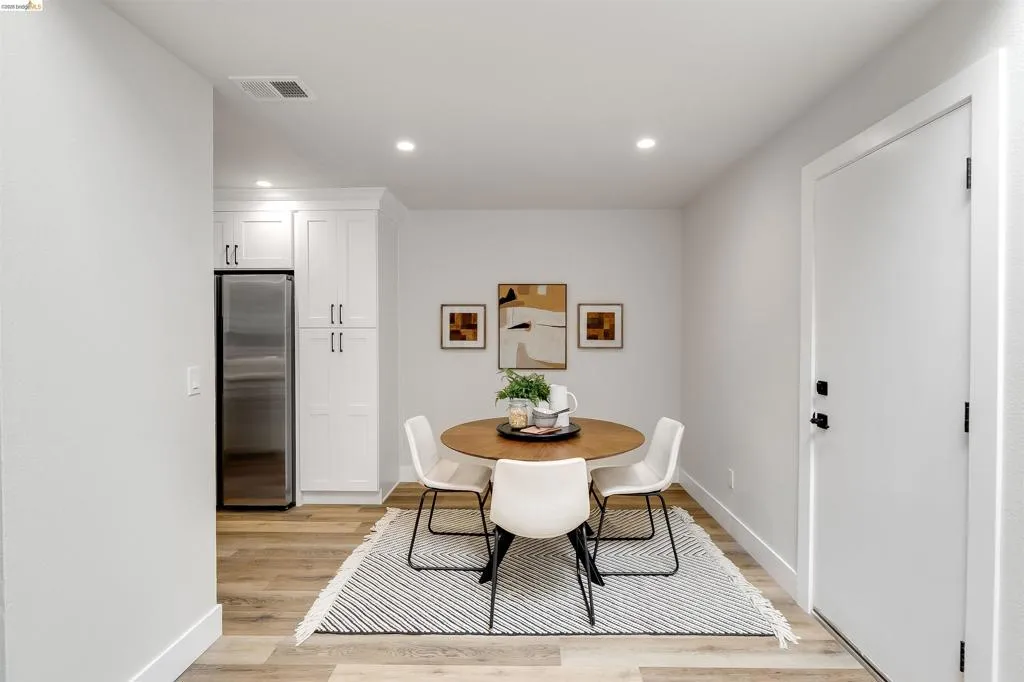 Dining area featuring wood-finish flooring, recessed lighting, and a neutral color palette