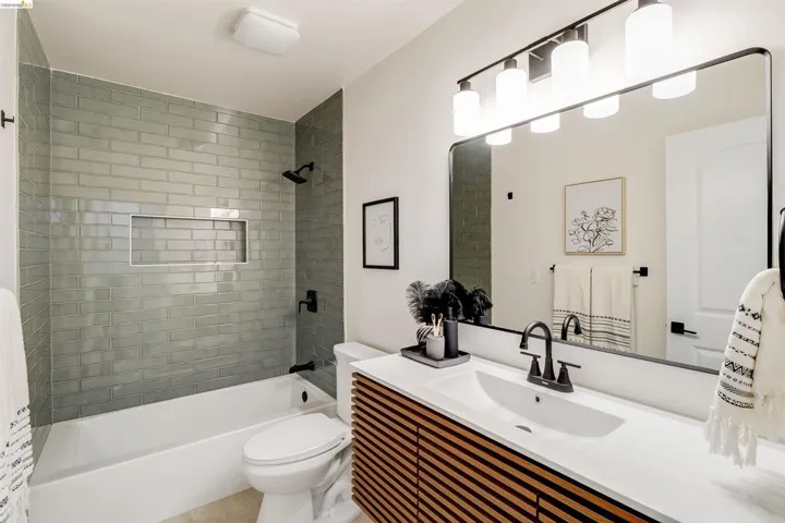 Bathroom featuring a tub/shower combination with subway tile surround and integrated niche