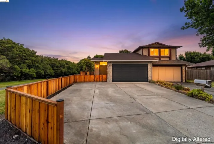 Two-story residence featuring a stone facade and a dual garage