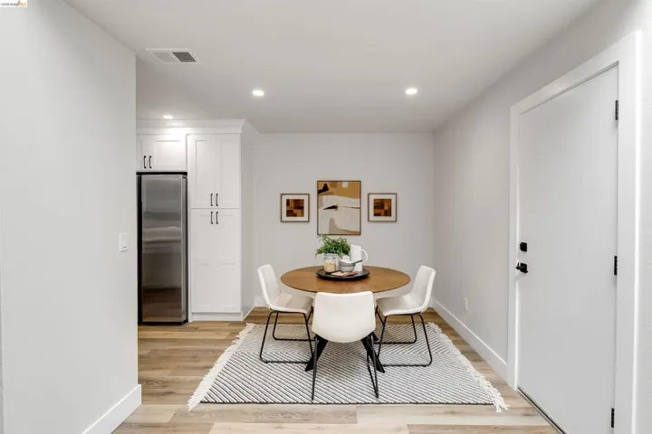 Dining area featuring wood-finish flooring, recessed lighting, and a neutral color palette