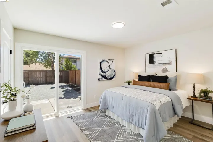 Bedroom with wood-finish flooring and a ceiling-mounted light fixture