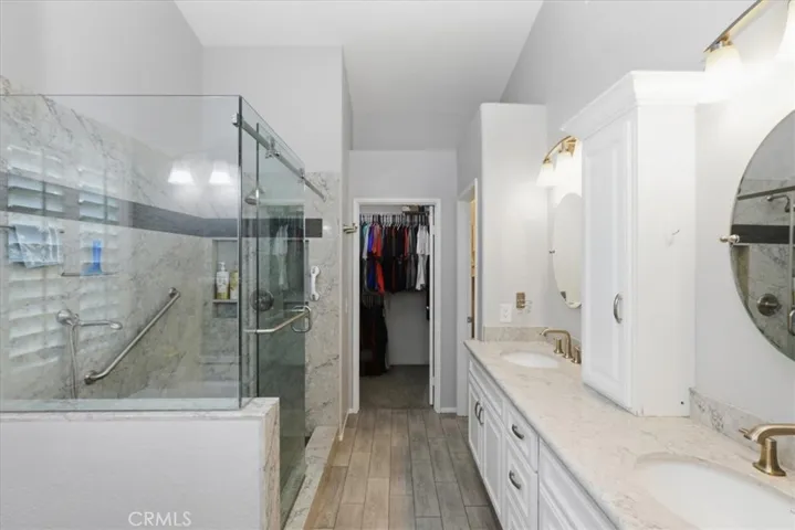 Primary bathroom with walk in glass enclosed shower-Temperature regulated shower head