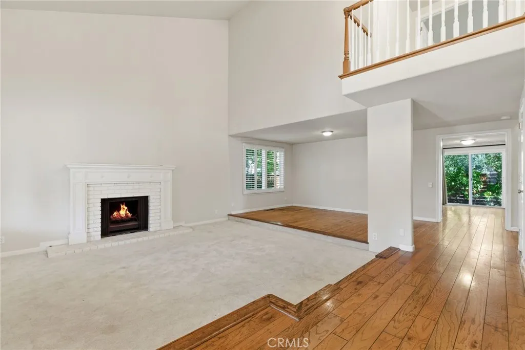 Enter into Living Room with High Ceilings and Dining Area