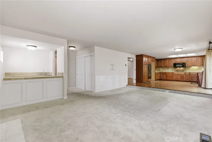 Family Room Area with Wet Bar, Bathroom, Laundry Room, Garage Access Down Hallway