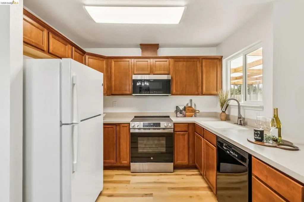 Kitchen with wood-finish cabinetry and light-toned countertops