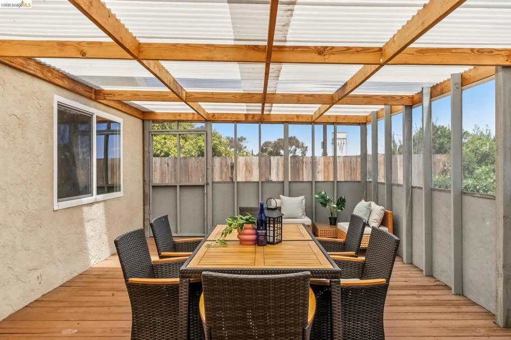 Covered outdoor patio featuring a wood deck and translucent roof panels