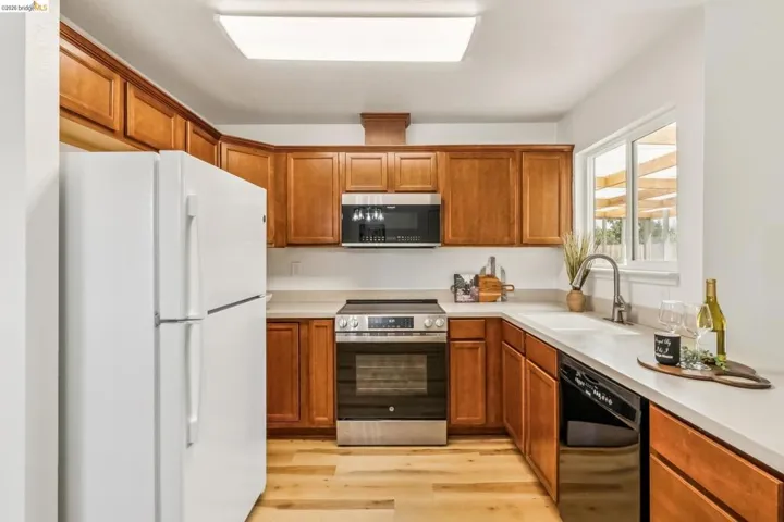 Kitchen with wood-finish cabinetry and light-toned countertops
