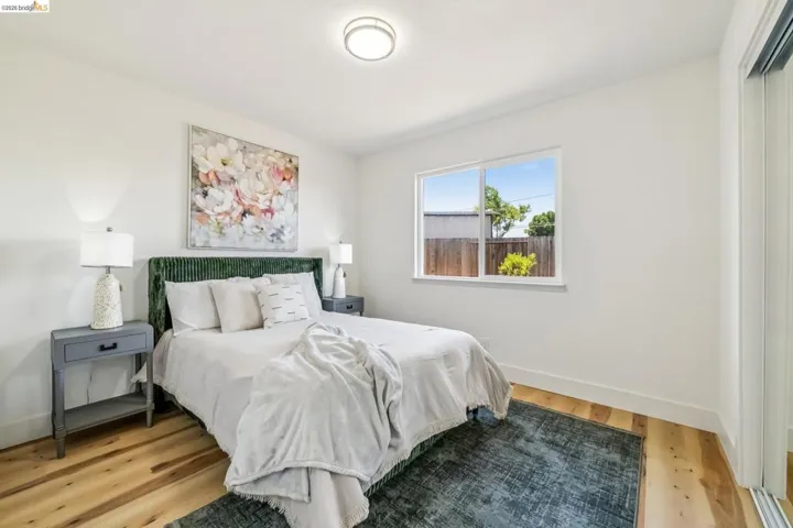 Hardwood-finish flooring complements crisp white walls and a large window