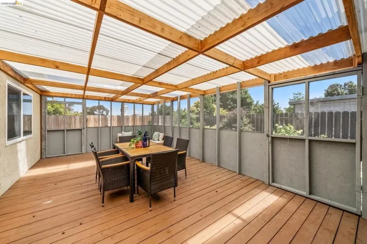 Spacious outdoor living area featuring a wood-finish deck