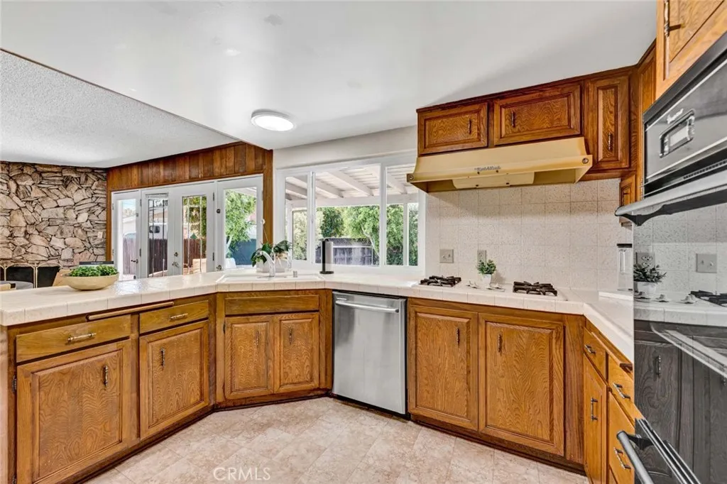 Kitchen with corner sink and picture window.