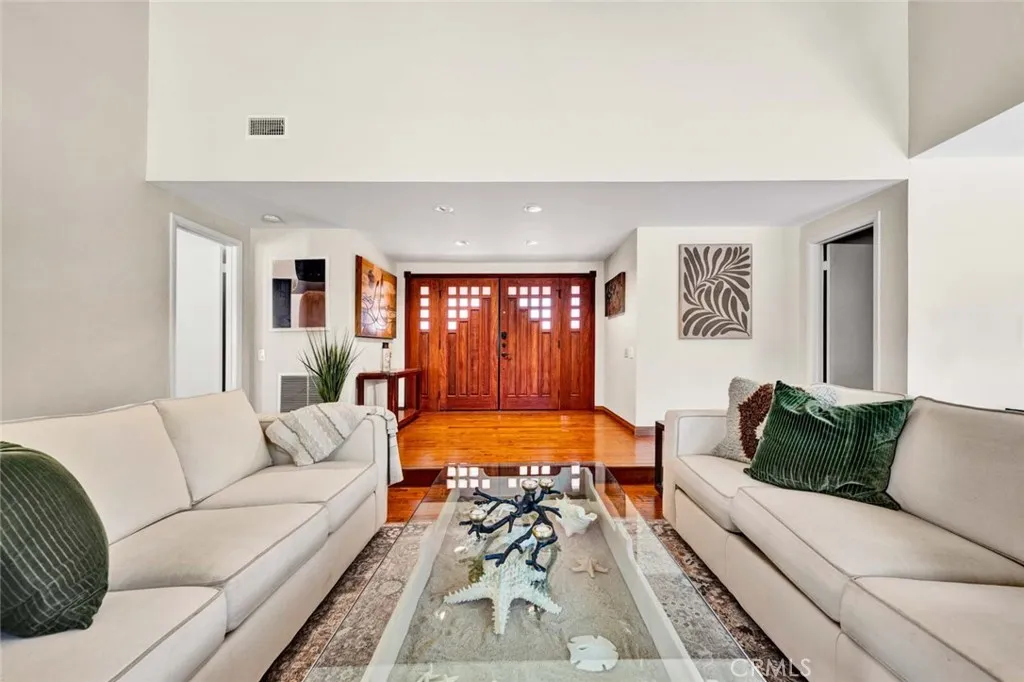Custom double entry wood doors and side lights.  Wood floor entry.