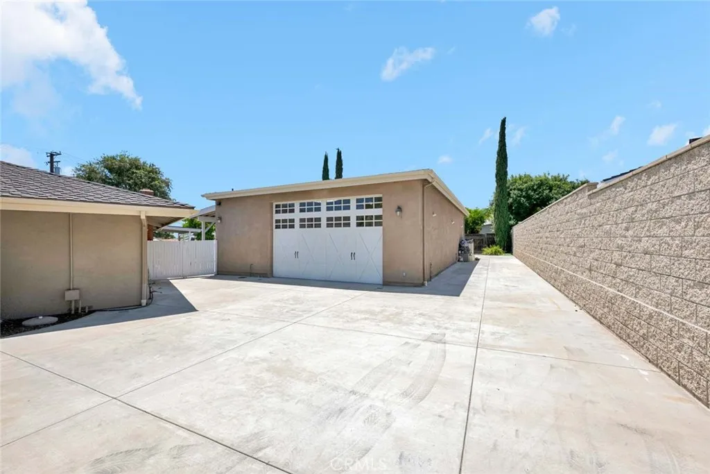Separate gate and driveway for 1500 sq. ft. extra high garage.